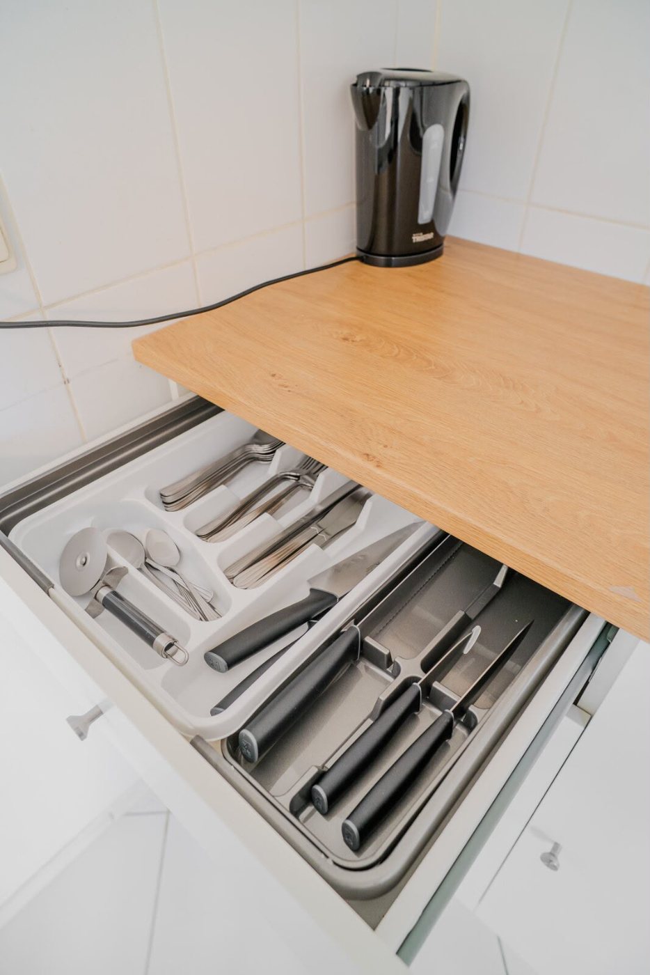 The cutlery drawer, the pots, the bathroom. Nobody photographs a cutlery drawer unless they have opened a few empty ones.