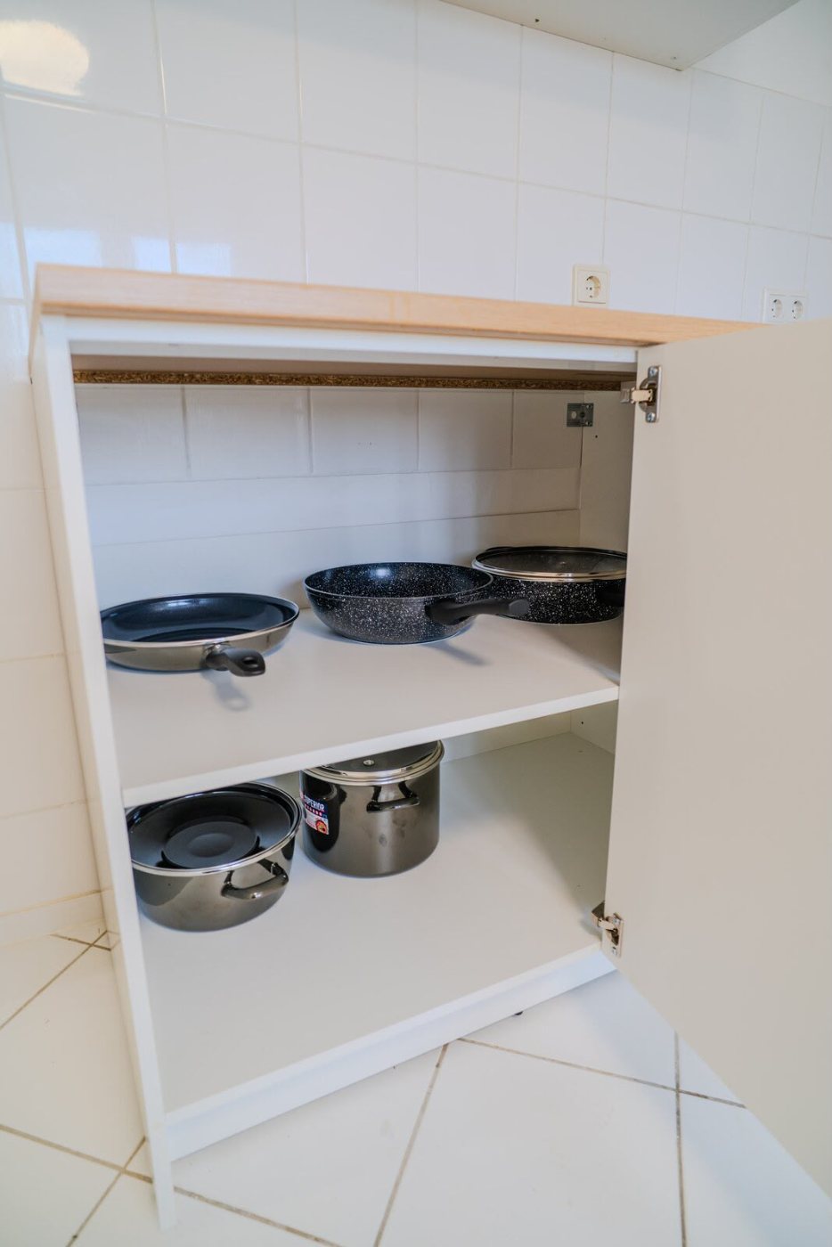 The cutlery drawer, the pots, the bathroom. Nobody photographs a cutlery drawer unless they have opened a few empty ones.